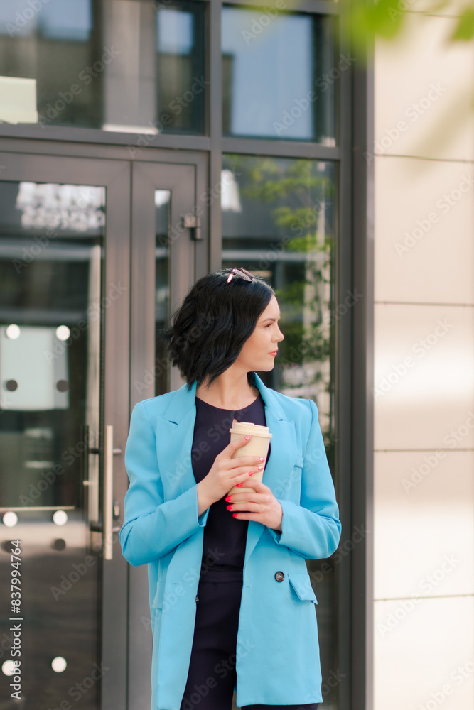 Young elegant Asian professional business woman, lady executive manager wearing suit holding coffee cup standing outdoor during work break. Young elegant Asian professional business woman, lady executive manager wearing suit holding coffee cup standing outdoor during work break.