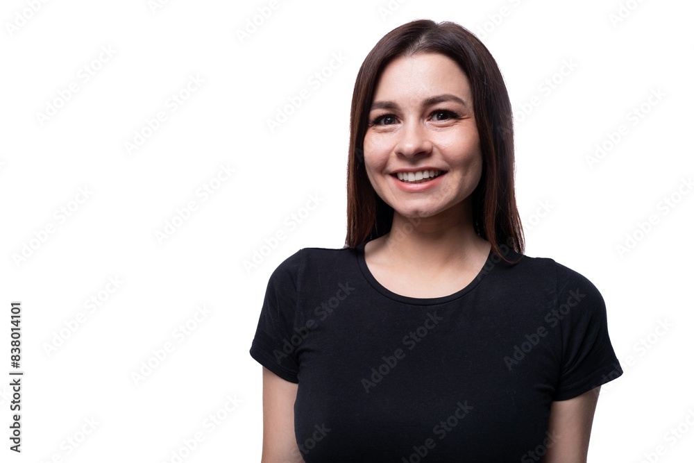 Positive pretty young brunette woman wearing a black t-shirt on a white background with copy space Positive pretty young brunette woman wearing a black t-shirt on a white background with copy space