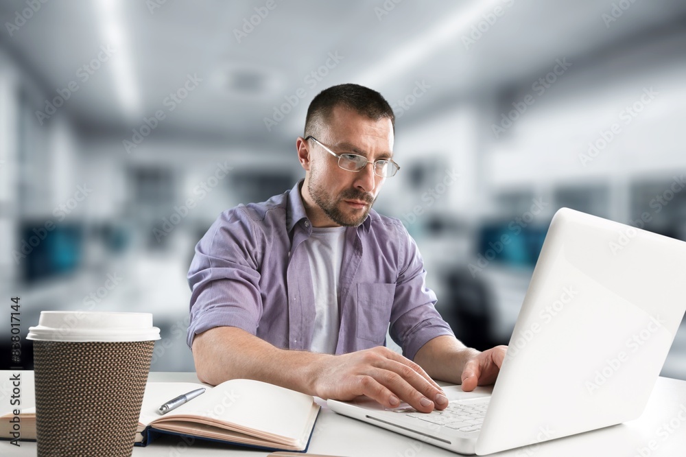 Male software worker using a laptop. Male software worker using a laptop.