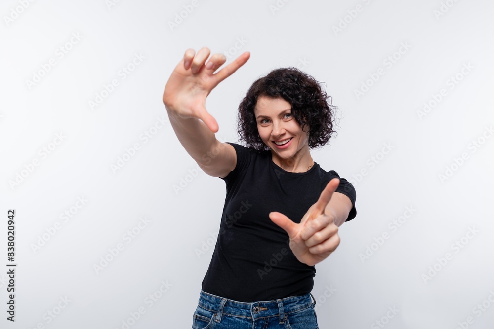 Dreamy brunette with curly hairstyle gesturing Dreamy brunette with curly hairstyle gesturing