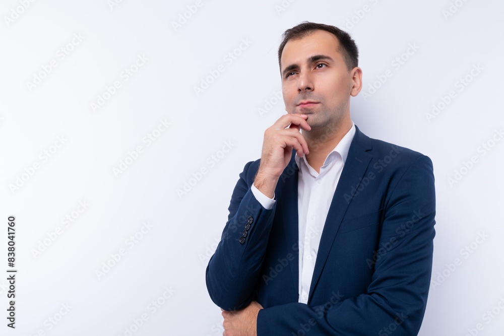 European 40 year old business man is puzzled by a problem and looks away