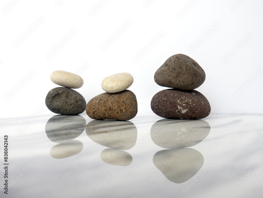 Zen basalt stone on white marble background Zen basalt stone on white marble background