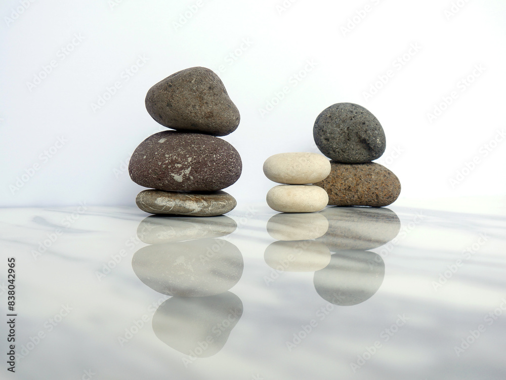 Zen basalt stone on white marble background Zen basalt stone on white marble background