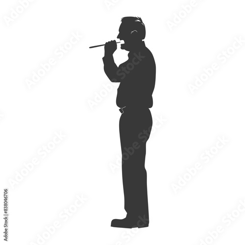 Silhouette of man in headset, using pipe for blowing.
