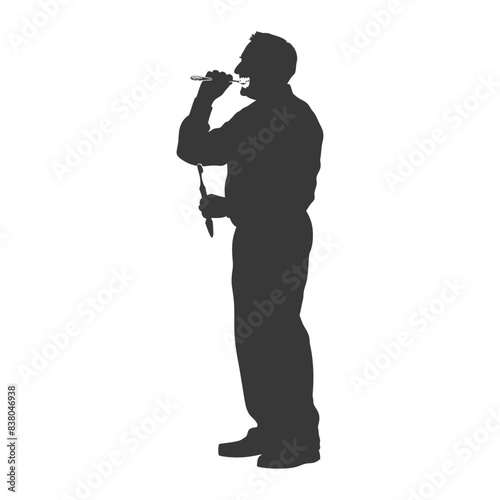 Silhouette of a Man Singing Karaoke into a Microphone.