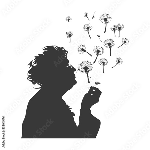 silhouette elderly woman blows dandelion flower black color only