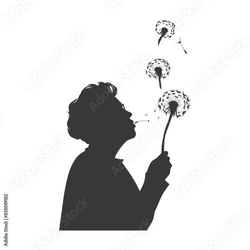 silhouette elderly woman blows dandelion flower black color only
