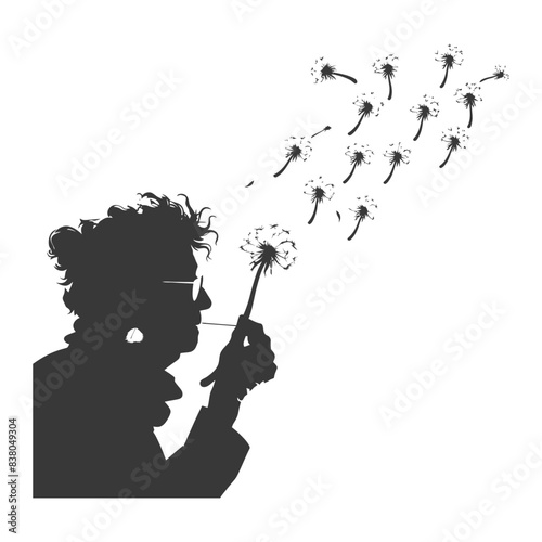 silhouette elderly woman blows dandelion flower black color only