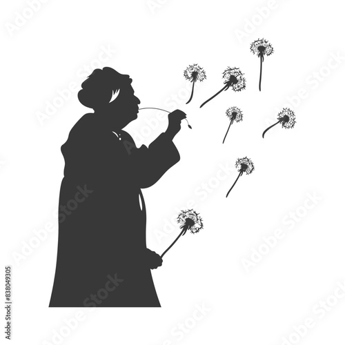 silhouette elderly woman blows dandelion flower black color only