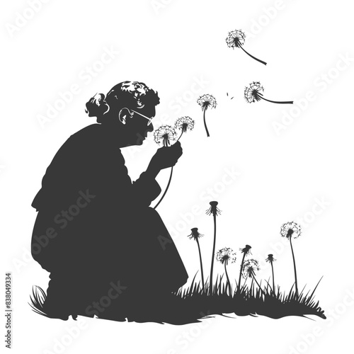 silhouette elderly woman blows dandelion flower black color only