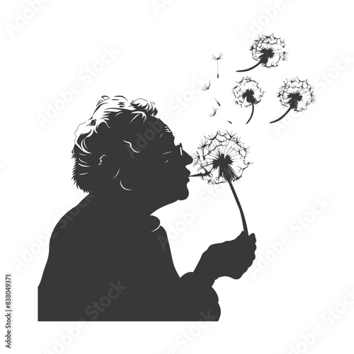 silhouette elderly woman blows dandelion flower black color only