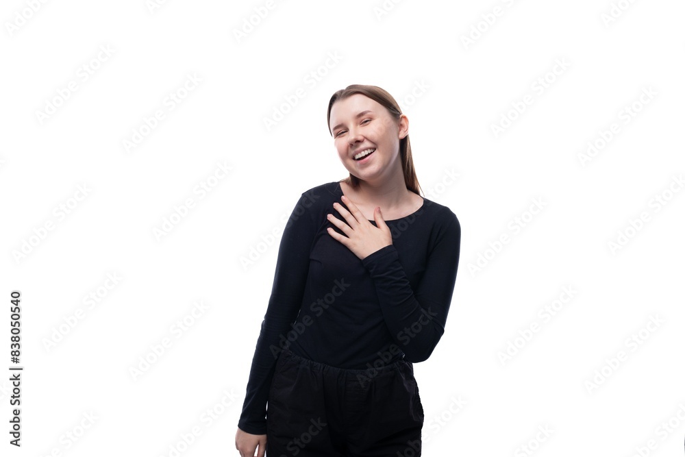 A school-age girl with brown hair laughs and is shy on a white background A school-age girl with brown hair laughs and is shy on a white background