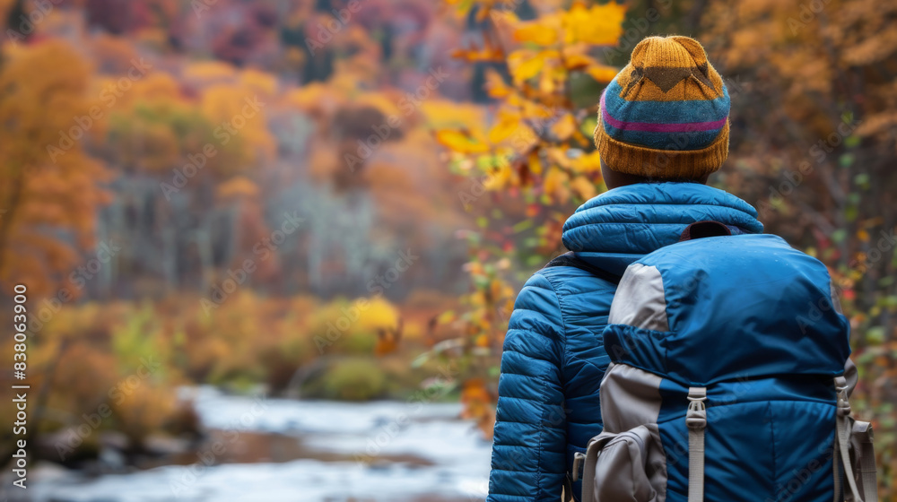 Autumn Hiker Enjoying Peaceful River Amidst Fall Foliage Autumn Hiker Enjoying Peaceful River Amidst Fall Foliage