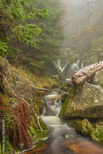 Cerny Stolpich waterfall on cold foggy autumn day photo