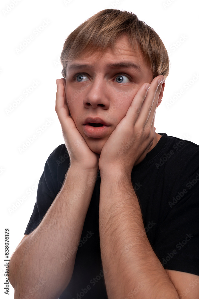 Headshot portrait of an unhappy blond Caucasian guy in a black T-shirt Headshot portrait of an unhappy blond Caucasian guy in a black T-shirt