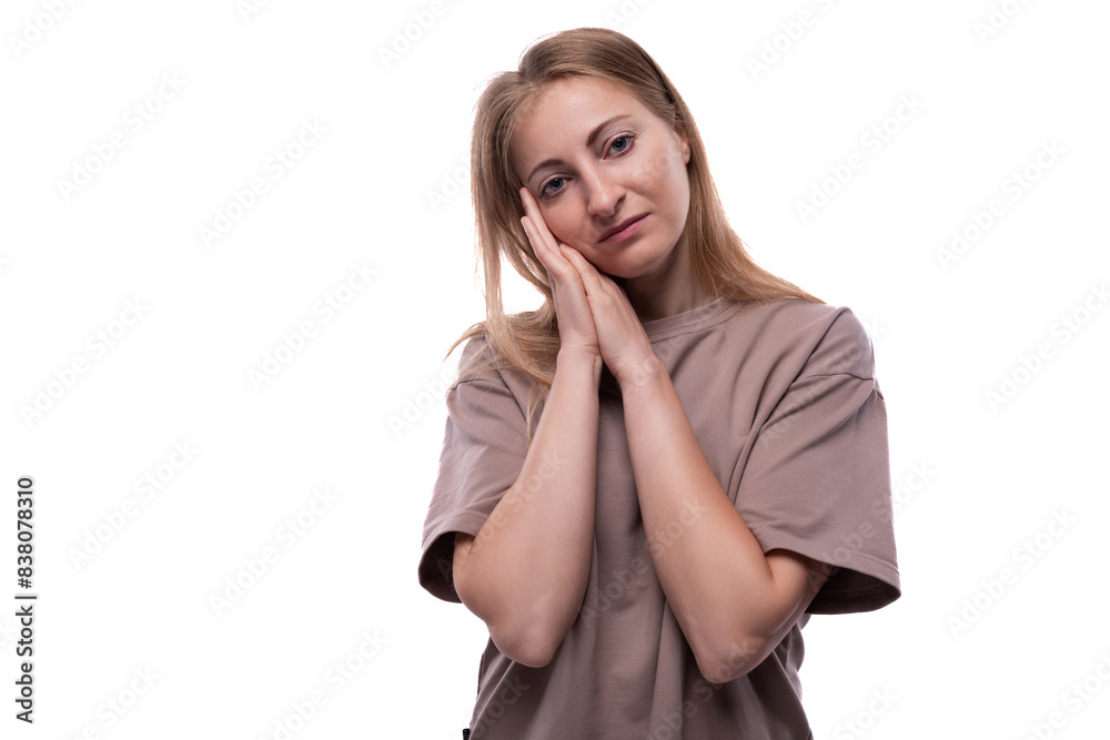 Portrait of a Caucasian 40 year old woman with flowing blonde hair wearing a basic T-shirt Portrait of a Caucasian 40 year old woman with flowing blonde hair wearing a basic T-shirt
