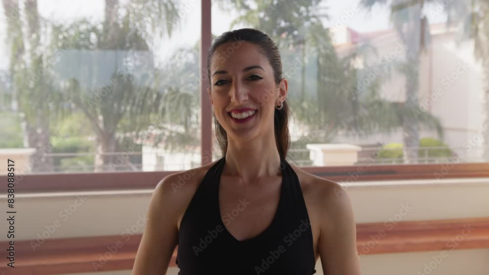 Woman In Black Tracksuit Smiles Amusedly In The Gym Woman In Black Tracksuit Smiles Amusedly In The Gym