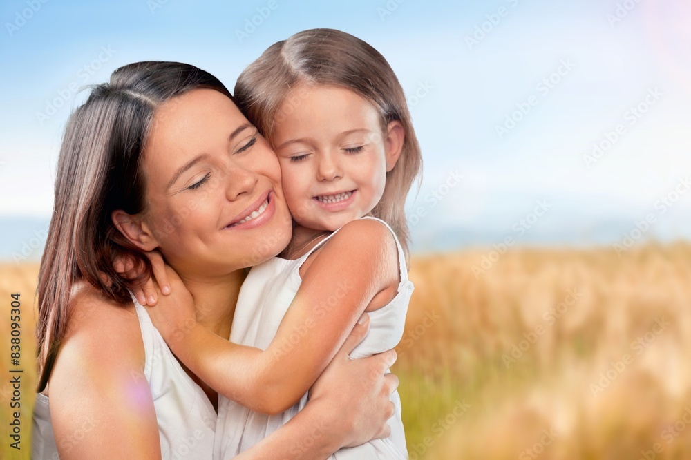 Tender scene of child with mom at nature background