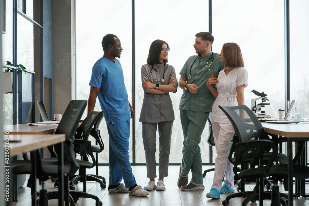 Front view. Group of doctors are together indoors