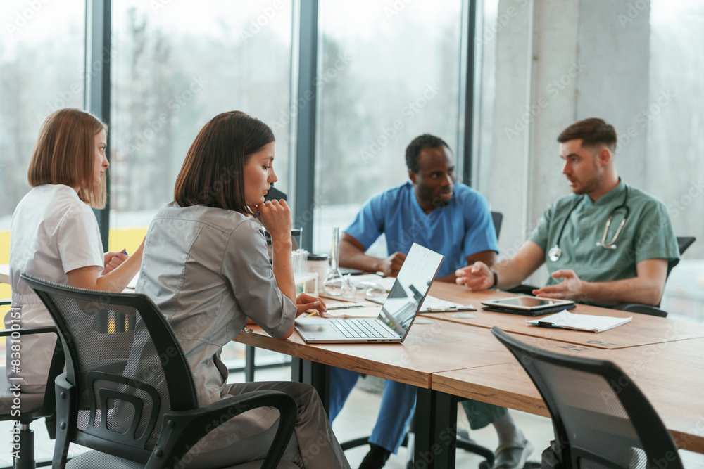 By the table. Group of doctors are together indoors By the table. Group of doctors are together indoors