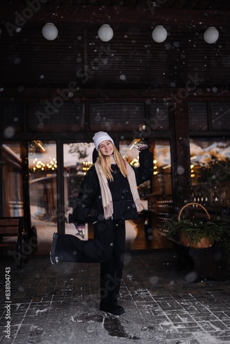 Portrait of a teenage girl outside a cafe in winter.