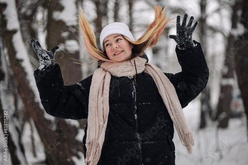 Funny teenage girl posing in the woods in winter.