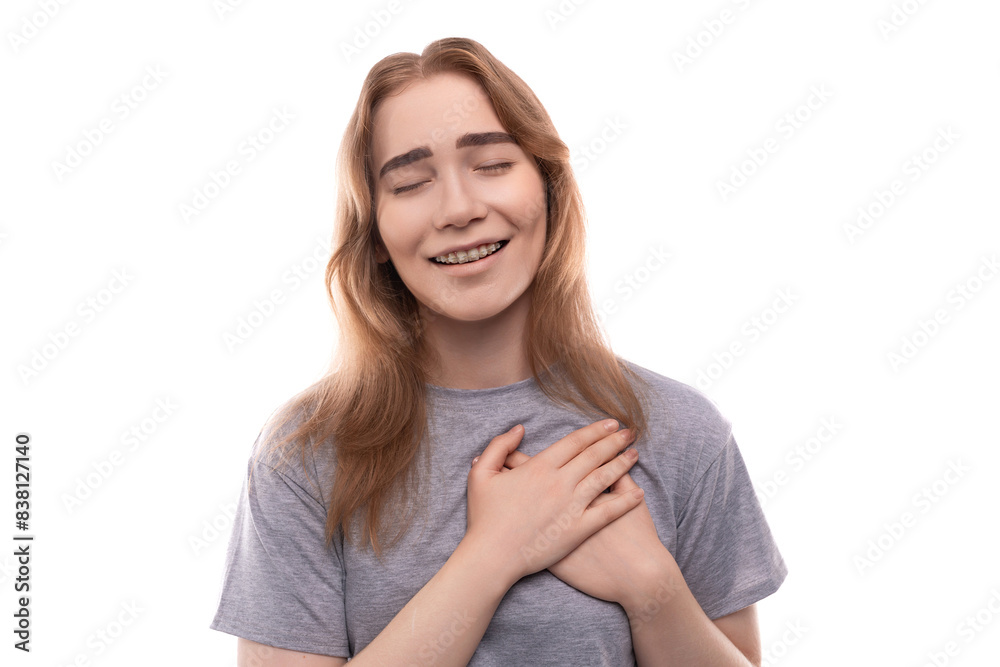 Kind modest bright blond teenager girl with braces in a gray T-shirt Kind modest bright blond teenager girl with braces in a gray T-shirt