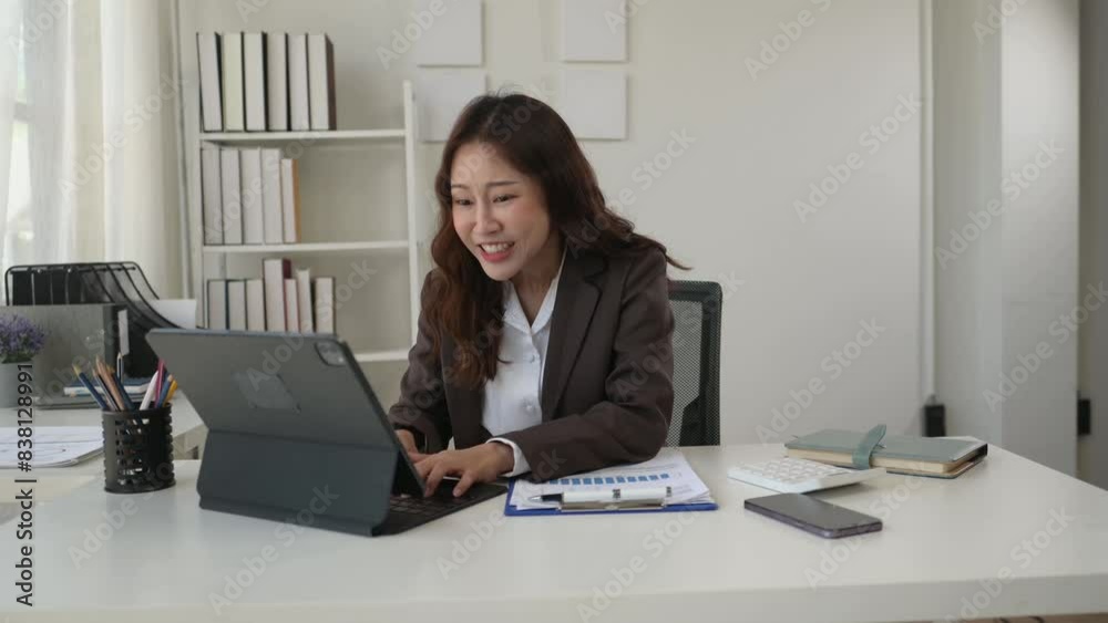 Young Asian woman sitting typing on a notebook Young Asian woman sitting typing on a notebook