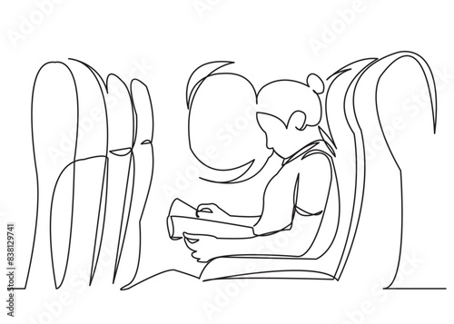 the girl in the airplane reads