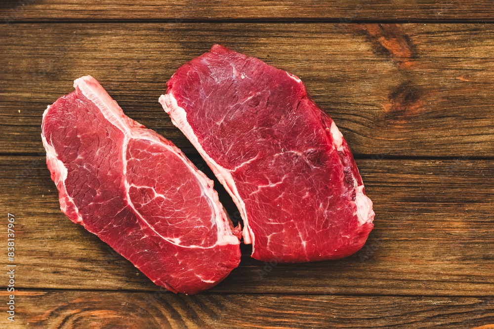 A piece of premium meat, striploin steak on a wooden table A piece of premium meat, striploin steak on a wooden table