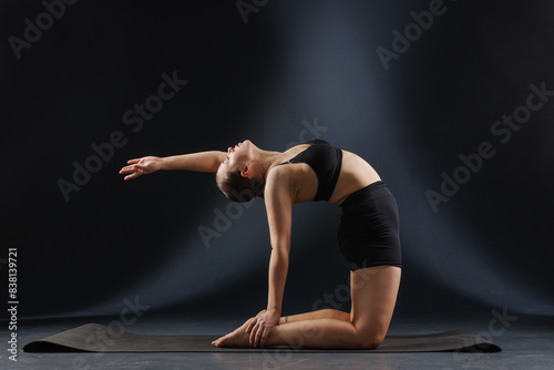 girl doing yoga and stretching  yoga and stretching poses on a dark background  yoga practice