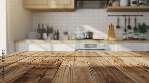 A wooden tabletop rests against a blurry blue kitchen room background. This is an example of a modern contemporary kitchen room. photo