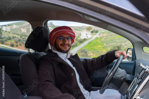Cheerful arabic driver in his car