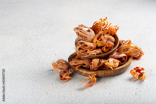 Fotografie Indian spice mace or javitri in wooden plates on gray background with copyspace