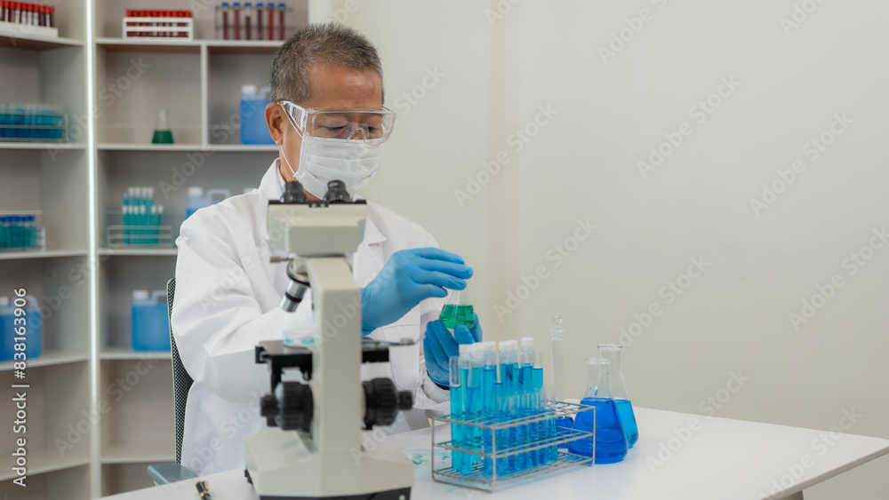Two senior Asian scientists working in a laboratory are scientists researching biology and chemistry. Couple wearing glasses and looking into a microscope, medical concept