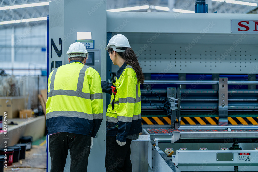 custom made wallpaper toronto digitalMale and female engineers in neat work clothes prepare and control the production system of large modern machines in a factory producing industrial technology products.