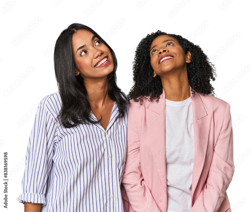Young Latin businesswomen in studio relaxed and happy laughing, neck stretched showing teeth. Young Latin businesswomen in studio relaxed and happy laughing, neck stretched showing teeth.