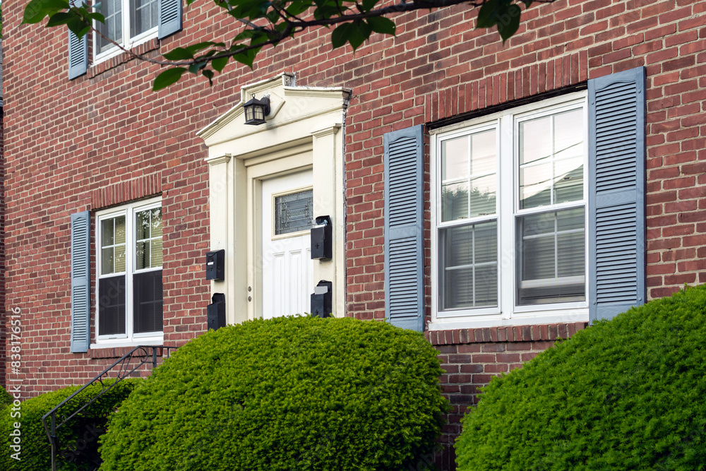 Exterior of an old brick multi-family house in Brighton, Massachusetts, USA