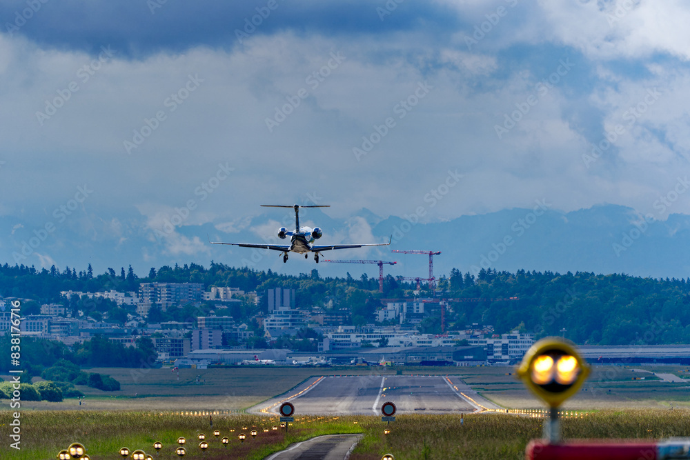Fototapeta premium Rear view of private jet landing at Zürich Airport on a spring day. Photo taken May 28th, 2024, Kloten, Canton Zurich, Switzerland.