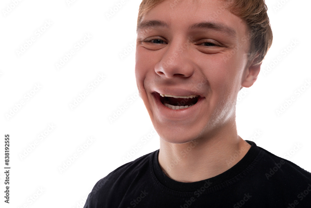 Caucasian blond 16 year old guy dressed in a black T-shirt close-up, cute smile Caucasian blond 16 year old guy dressed in a black T-shirt close-up, cute smile