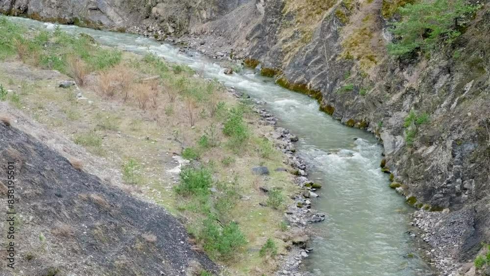 mountain river flows into gorge, slow motion
mountain river flows into gorge, slow motion