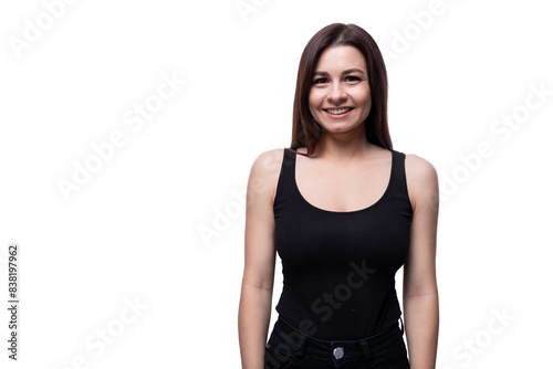 Young slim brunette woman wearing a tight T-shirt on a white background