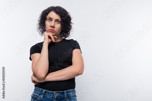 Adult curly European woman wearing a black t-shirt inspired by an idea