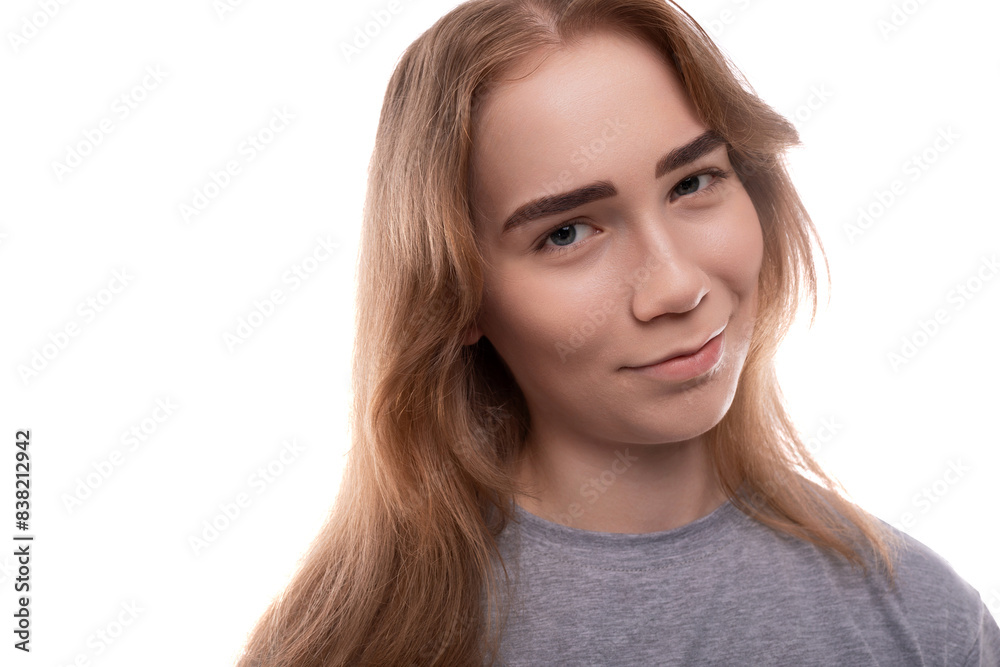 Blonde teenage girl of European appearance with braces in a gray T-shirt on a background with copy space Blonde teenage girl of European appearance with braces in a gray T-shirt on a background with copy space