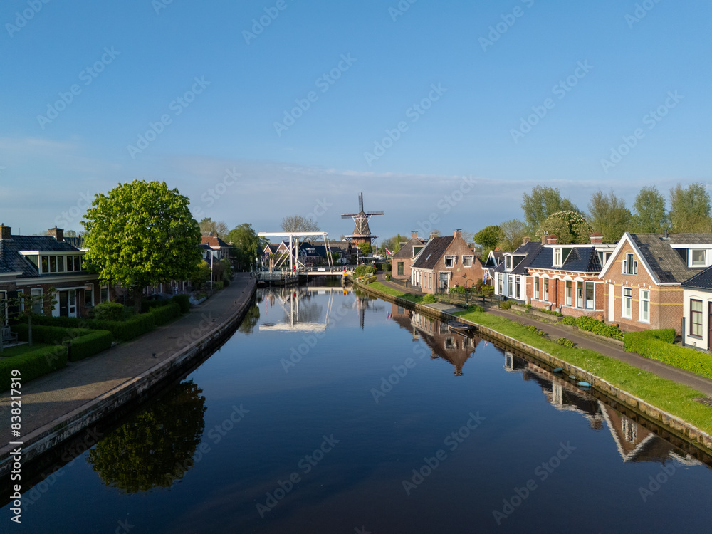 Aerial View: Village Burdaard in Friesland, Netherlands with houses Aerial View: Village Burdaard in Friesland, Netherlands with houses