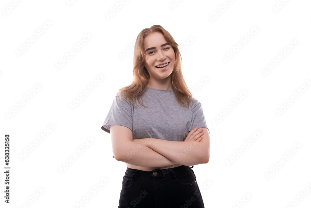 Portrait of a modest teenager girl with braces in a gray T-shirt on a white background Portrait of a modest teenager girl with braces in a gray T-shirt on a white background