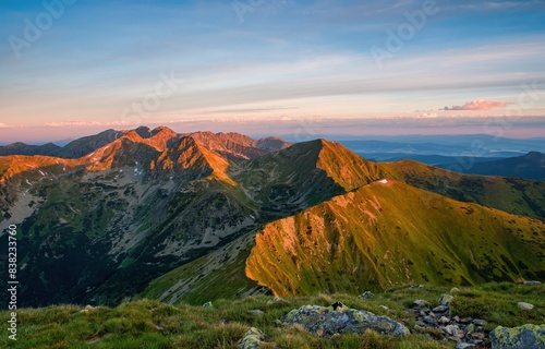 Fototapeta Naklejka Na Ścianę i Meble -  Summer in the polish tatra mountains, mountain peaks in Western Tatras mountains in Poland and Slovakia with other peaks scenery, hiking trail, relaxing people on stone and blue sky with clouds.
