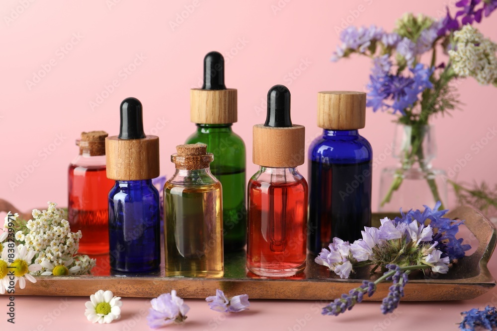 Aromatherapy. Different essential oils and flowers on pink background Aromatherapy. Different essential oils and flowers on pink background