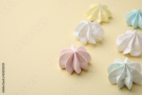 Delicious meringue cookies on beige background  closeup. Space for text