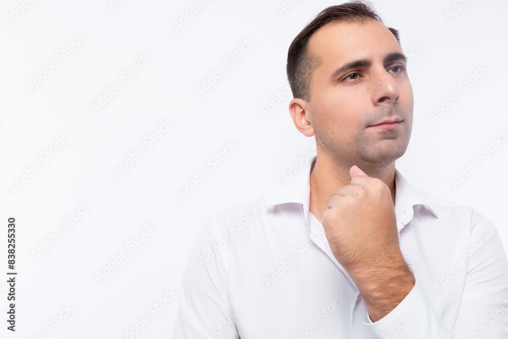 Brunette office man in a white shirt looks thoughtfully to the side close-up portrait Brunette office man in a white shirt looks thoughtfully to the side close-up portrait